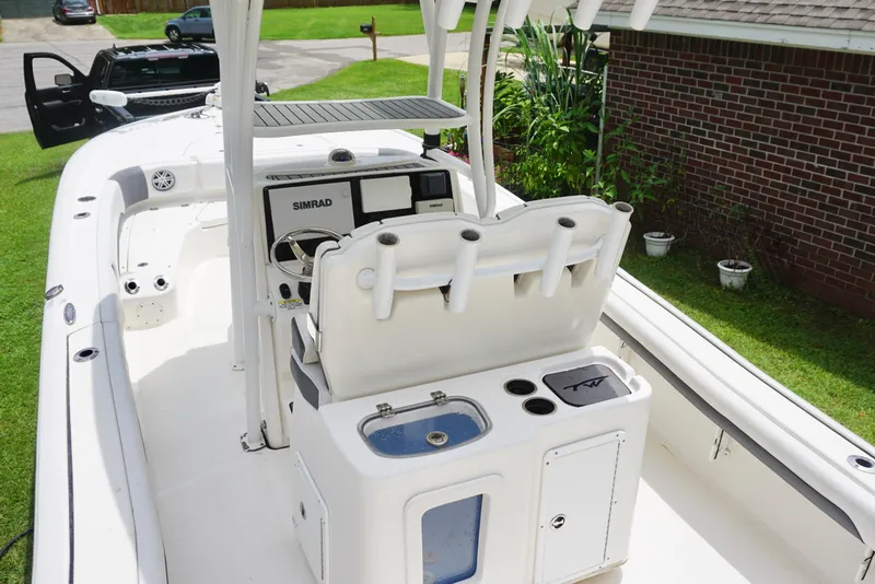 Slide: The Image of 2019 Tidewater 2700 Carolina Bay boat interior with Simrad electronics and fishing rod holders. - 22