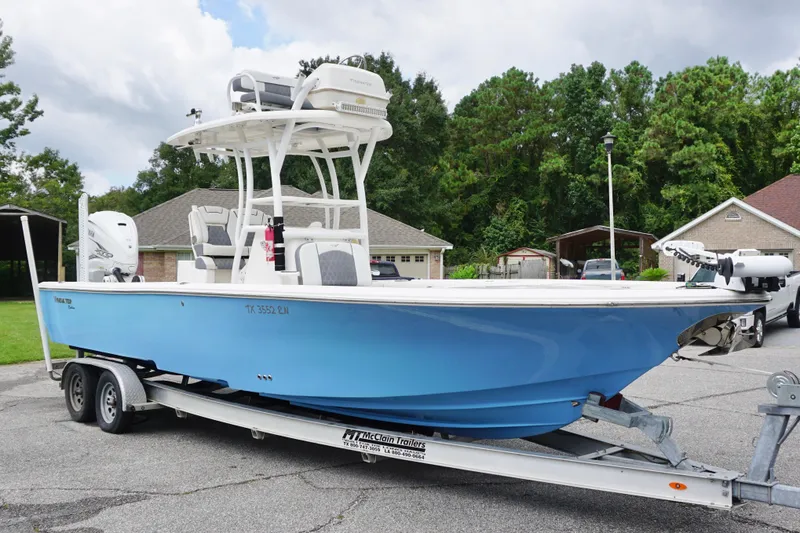 Slide: The Image of 2019 Tidewater 2700 Carolina Bay boat on trailer, parked in residential area. - 3