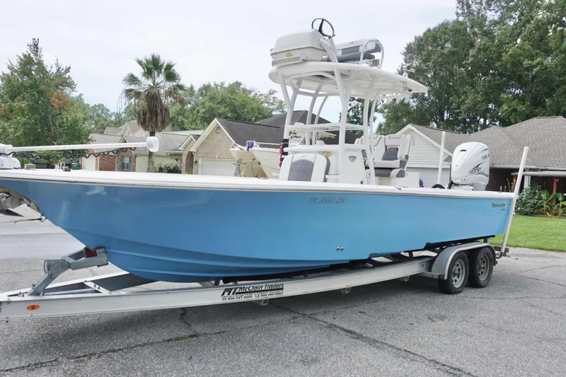 Slide: The Image of 2019 Tidewater 2700 Carolina Bay boat on trailer, parked in residential area. - 4