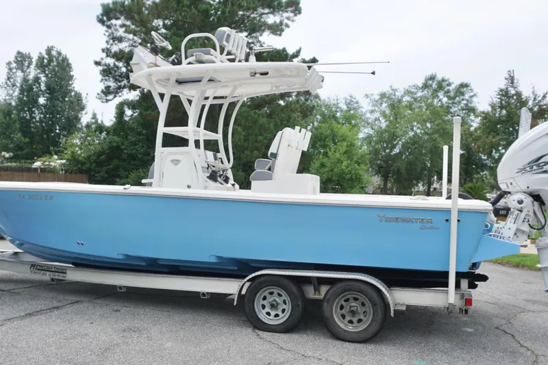 Slide: The Image of 2019 Tidewater 2700 Carolina Bay boat on trailer, blue hull, parked outdoors. - 5
