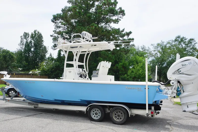 Slide: The Image of 2019 Tidewater 2700 Carolina Bay boat on trailer, blue hull, Yamaha engine, parked outdoors. - 9