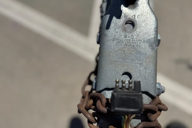 Slide: The Image of Close-up of a trailer hitch with chains and wiring, suitable for a 2017 Yamaha Boats AR190. - 12