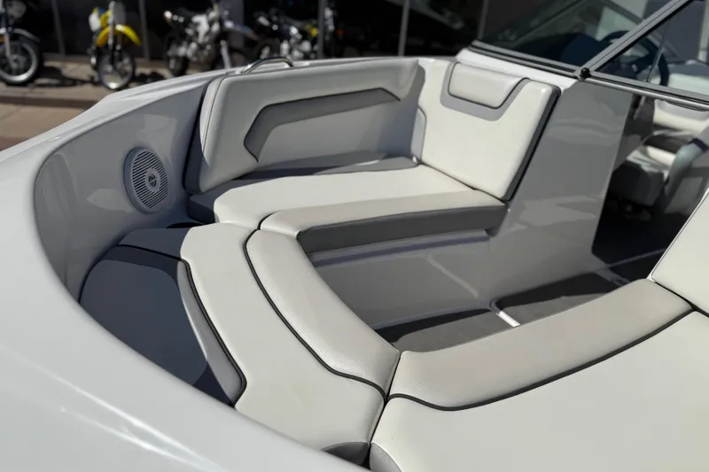 Slide: The Image of 2017 Yamaha Boats AR190 interior seating with white upholstery and speaker detail. - 14