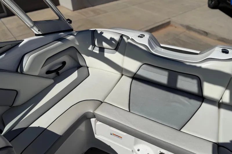 Slide: The Image of 2017 Yamaha Boats AR190 interior seating with gray and white upholstery. - 27