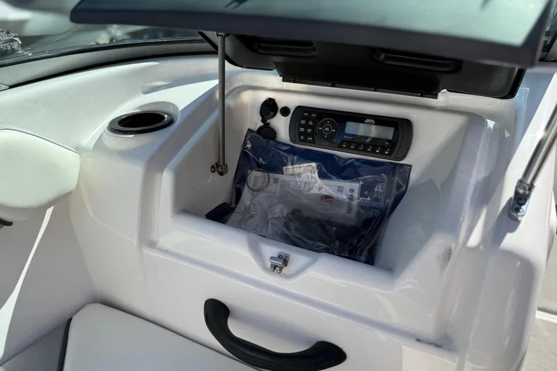 Slide: The Image of 2017 Yamaha AR190 boat dashboard with stereo system and storage compartment. - 35