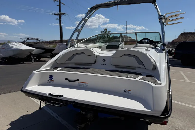 Slide: The Image of 2017 Yamaha Boats AR190, rear view, parked outdoors under clear sky. - 5