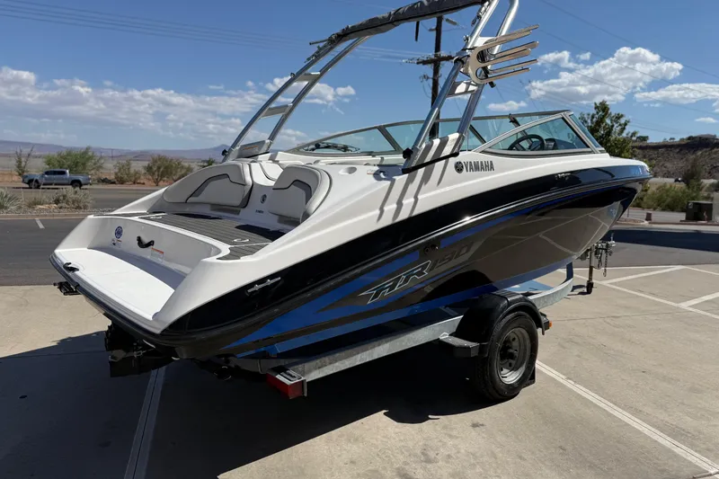 Slide: The Image of 2017 Yamaha AR190 boat on trailer, parked outdoors under clear sky. - 6