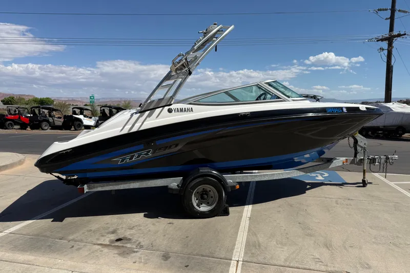Slide: The Image of 2017 Yamaha AR190 boat on trailer, parked outdoors under a clear sky. - 7