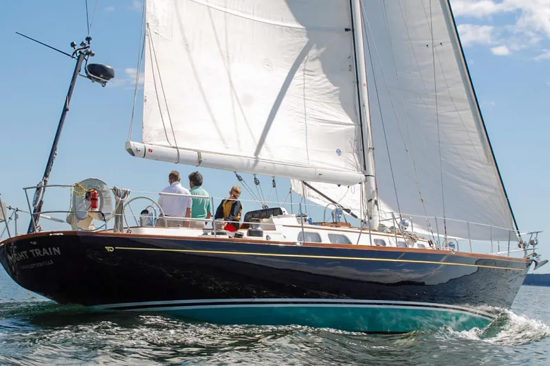 Slide: The Image of 1986 Hinckley Sou'wester 51 sailboat cruising on open water under clear skies. - 1