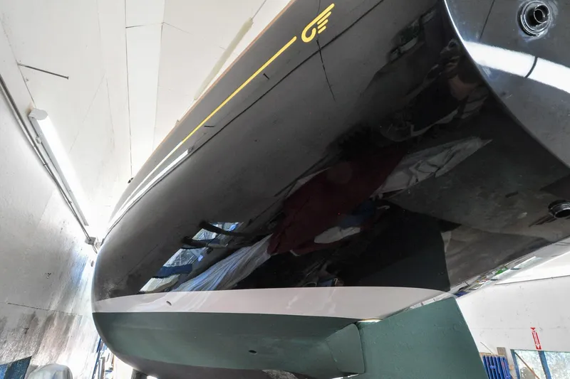 Slide: The Image of Hinckley Sou'wester 51 yacht, 1986 model, sleek black hull in a workshop setting. - 11