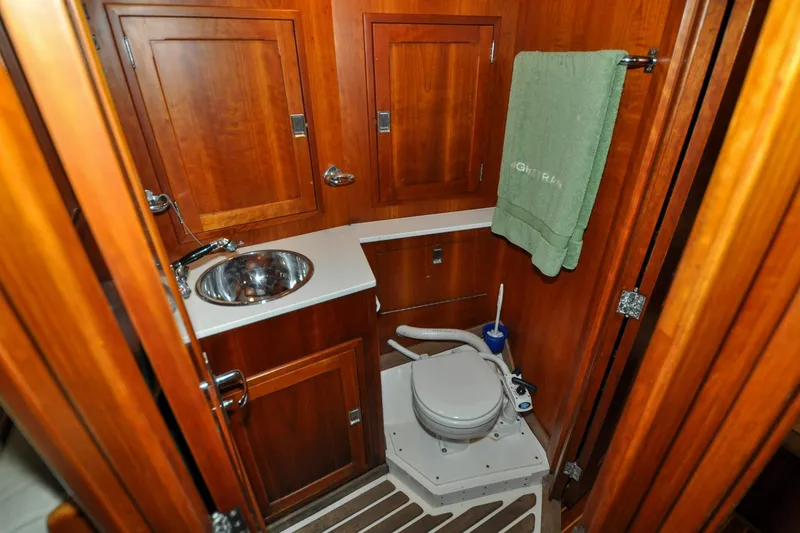 Slide: The Image of Hinckley Sou'wester 51 yacht bathroom, 1986 model, featuring wooden cabinetry and compact design. - 114