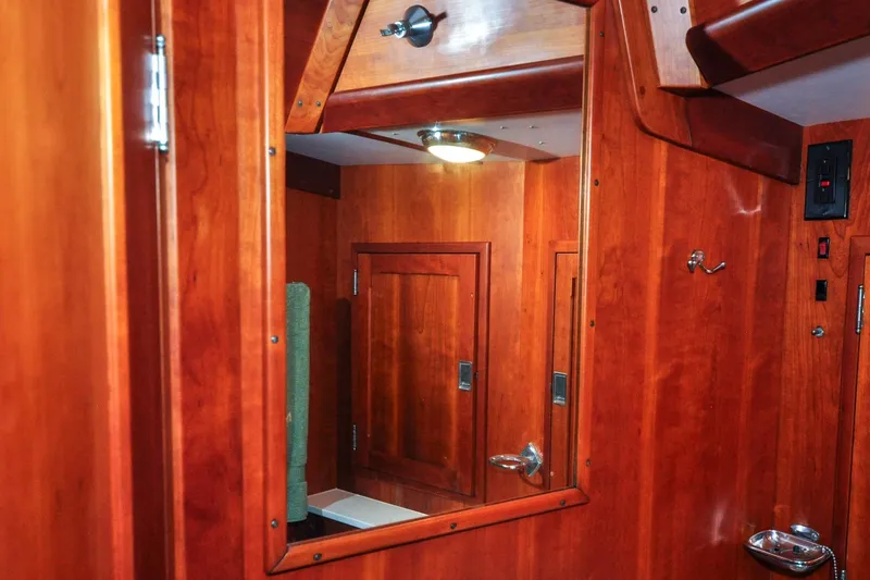 Slide: The Image of Interior of 1986 Hinckley Sou'wester 51 yacht with polished wood finish and mirror. - 118
