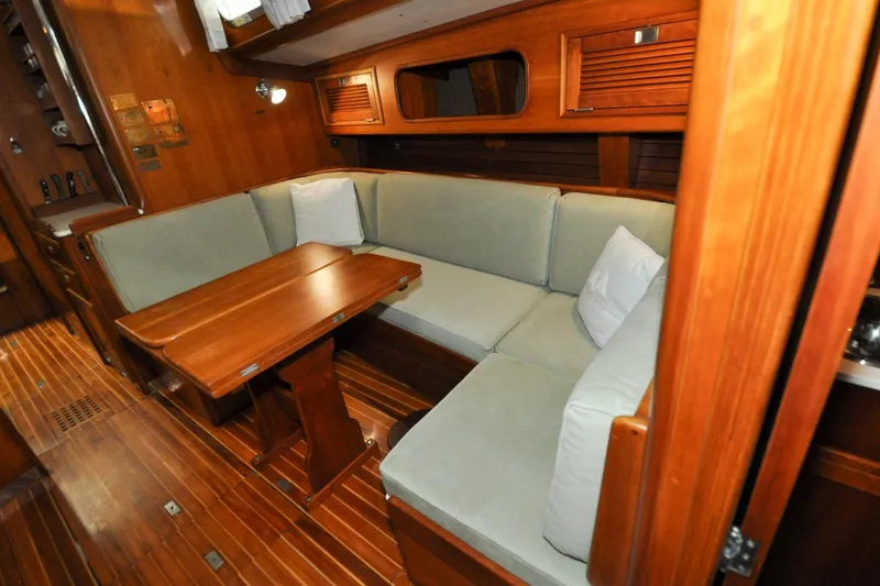 Slide: The Image of Luxurious wooden interior of 1986 Hinckley Sou'wester 51 yacht with cozy seating area. - 119
