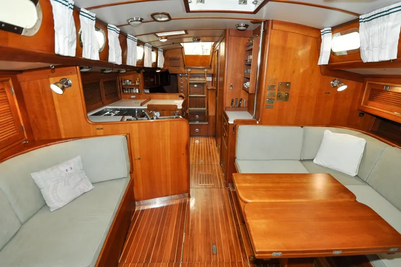 Slide: The Image of Interior of 1986 Hinckley Sou'wester 51 yacht with wooden finishes and cozy seating area. - 123