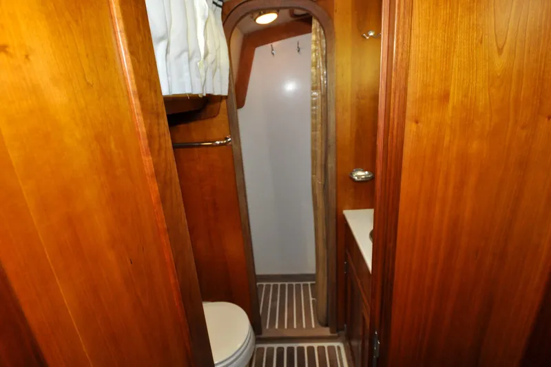 Slide: The Image of Interior of 1986 Hinckley Sou'wester 51 yacht bathroom with wooden cabinetry. - 128