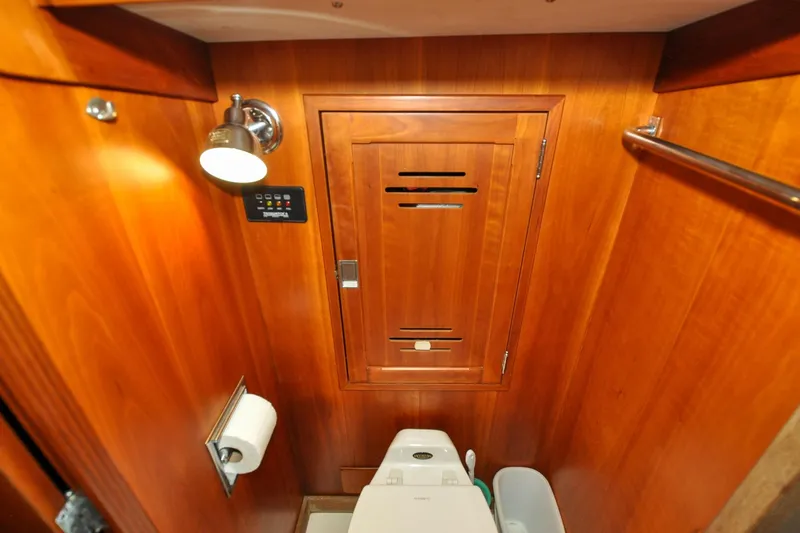 Slide: The Image of Hinckley Sou'wester 51 yacht bathroom, 1986, featuring wooden cabinetry and modern fixtures. - 133