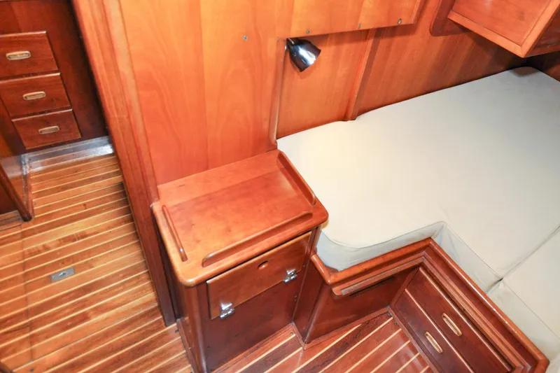 Slide: The Image of Hinckley Sou'wester 51 (1986) cabin interior with wooden cabinetry and flooring. - 141