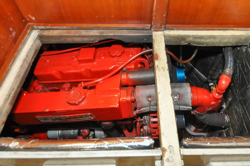Slide: The Image of Engine compartment of 1986 Hinckley Sou'wester 51 sailboat, featuring a red engine. - 145
