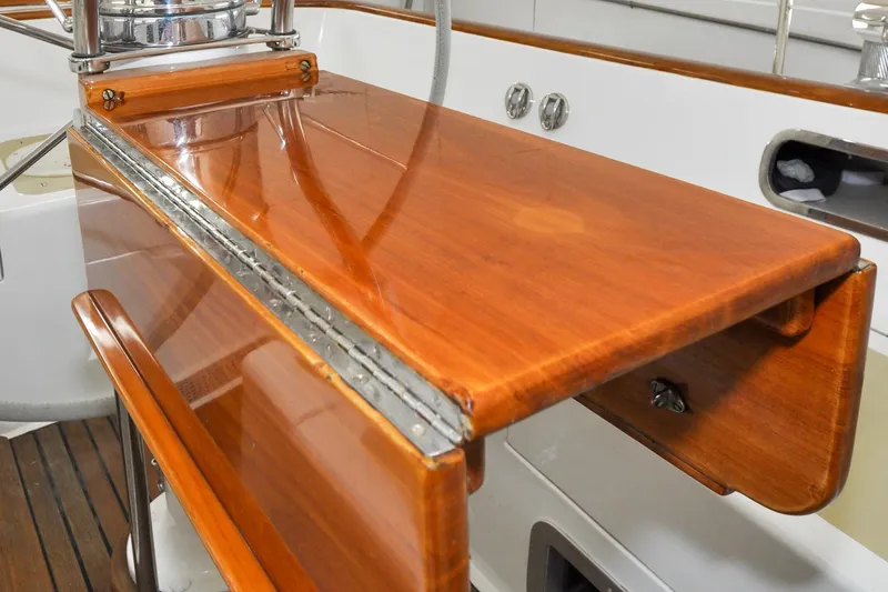 Slide: The Image of Polished wooden helm station on 1986 Hinckley Sou'wester 51 sailboat. - 17