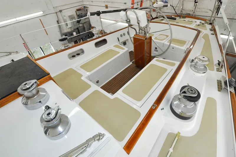 Slide: The Image of 1986 Hinckley Sou'wester 51 sailboat cockpit with winches and steering wheel in a workshop. - 42