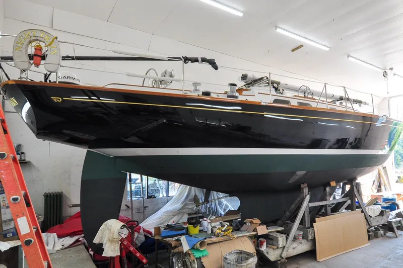 Slide: The Image of 1986 Hinckley Sou'wester 51 sailboat in a workshop, elevated on supports. - 5