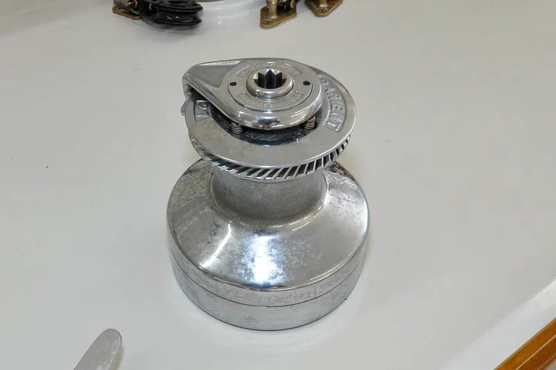 Slide: The Image of Winch on 1986 Hinckley Sou'wester 51 sailboat deck, showcasing polished metal finish. - 59