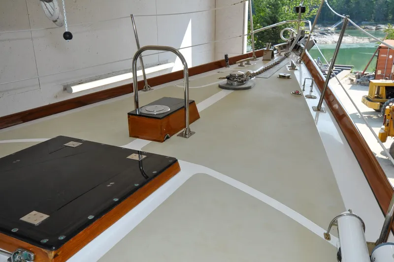 Slide: The Image of Deck of 1986 Hinckley Sou'wester 51 sailboat, featuring polished wood and metal fittings. - 65