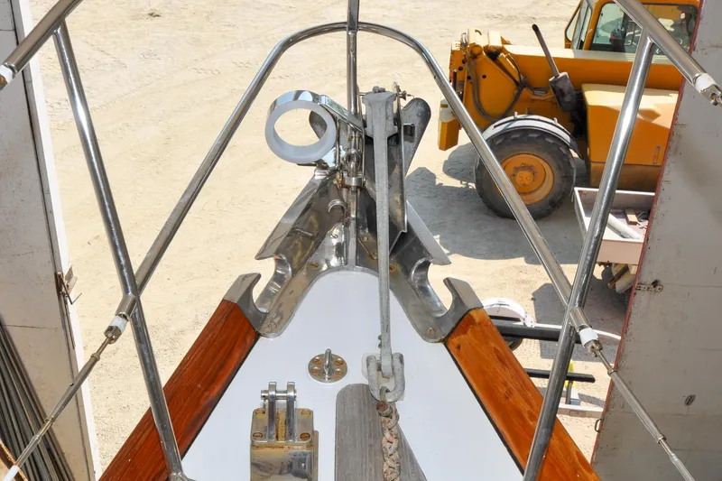 Slide: The Image of Bow of 1986 Hinckley Sou'wester 51 sailboat with anchor, in a shipyard setting. - 71