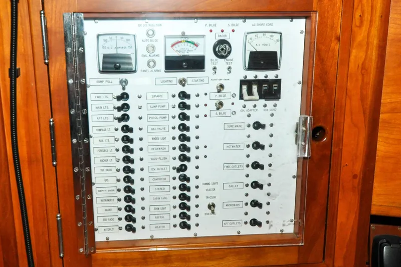 Slide: The Image of Electrical control panel on a 1986 Hinckley Sou'wester 51 sailboat, featuring switches and gauges. - 79
