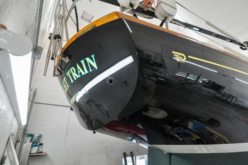 Slide: The Image of Hinckley Sou'wester 51 sailboat, 1986 model, in a workshop, showcasing sleek black hull design. - 9