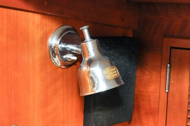 Slide: The Image of Chrome light fixture on 1986 Hinckley Sou'wester 51 yacht's wooden interior. - 100