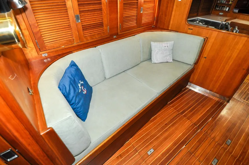 Slide: The Image of Luxurious interior of 1986 Hinckley Sou'wester 51 yacht with wooden finish and cozy seating. - 104