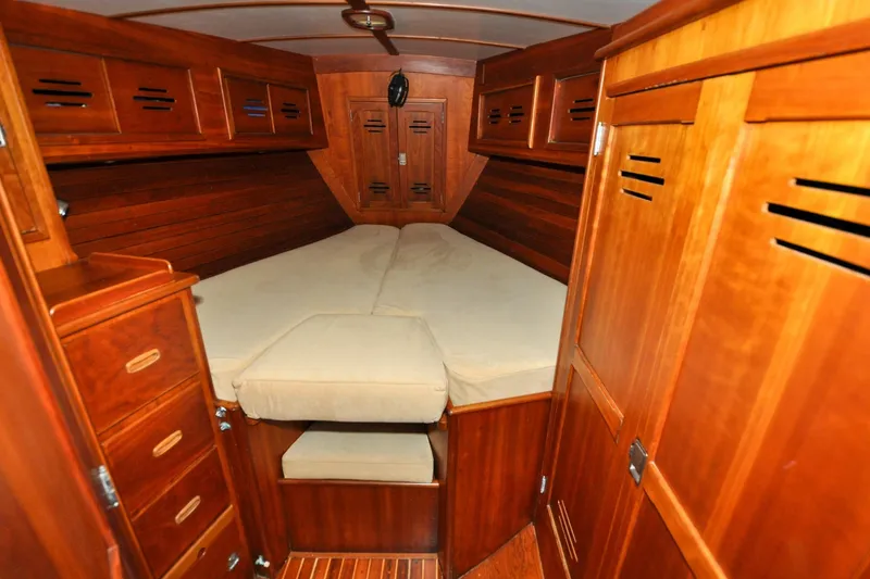 Slide: The Image of 1986 Hinckley Sou'wester 51 yacht cabin with wooden interior and cozy bed. - 107
