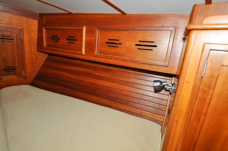 Slide: The Image of Hinckley Sou'wester 51 (1986) cabin interior with wooden paneling and built-in storage. - 109