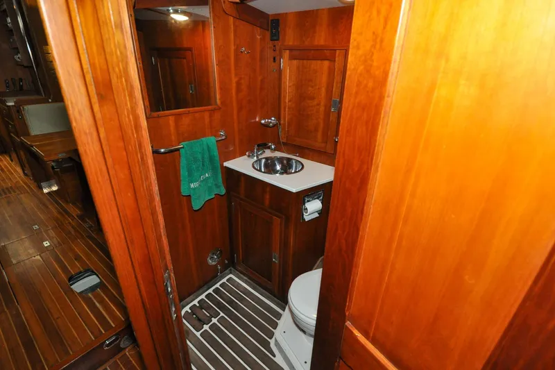 Slide: The Image of 1986 Hinckley Sou'wester 51 yacht bathroom with wooden interior and compact amenities. - 113