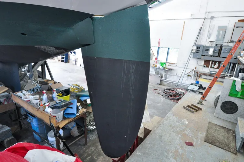 Slide: The Image of 1986 Hinckley Sou'wester 51 sailboat keel in a workshop setting. - 12