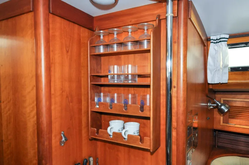 Slide: The Image of Wooden interior of 1986 Hinckley Sou'wester 51 yacht with glass and mug storage. - 124