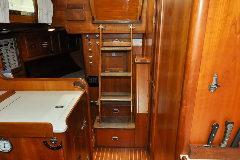 Slide: The Image of Interior of 1986 Hinckley Sou'wester 51 sailboat with wooden cabinetry and ladder. - 126