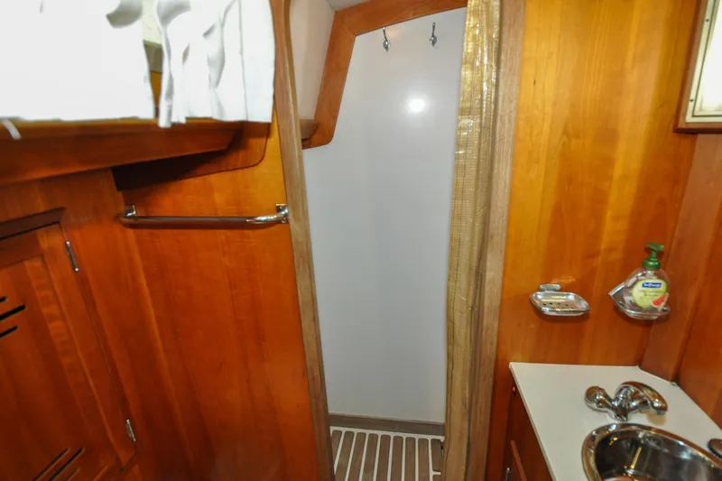 Slide: The Image of Hinckley Sou'wester 51 yacht bathroom, 1986 model, featuring wooden cabinetry and compact sink. - 130