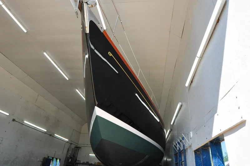 Slide: The Image of 1986 Hinckley Sou'wester 51 sailboat in a well-lit indoor facility. - 14