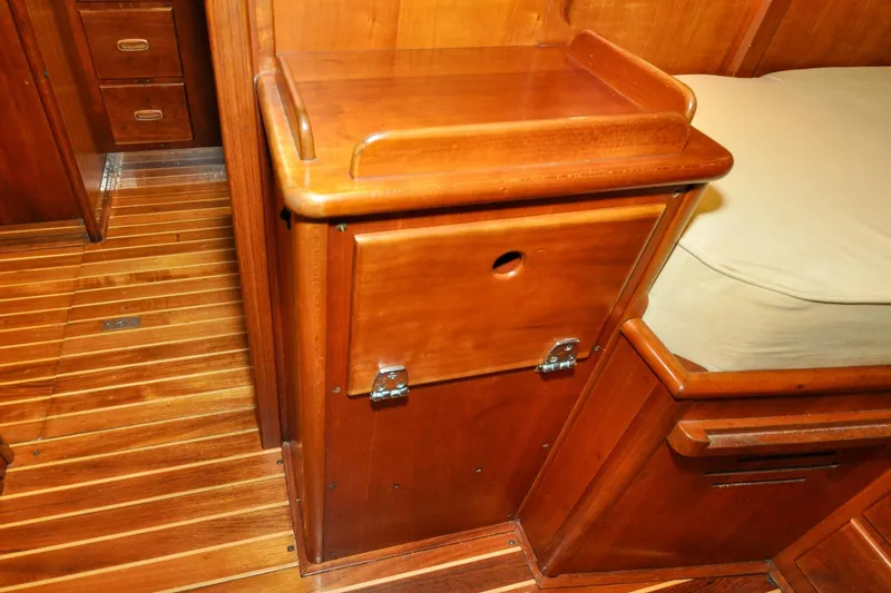 Slide: The Image of Wooden interior of 1986 Hinckley Sou'wester 51 yacht, featuring polished cabinetry and flooring. - 142