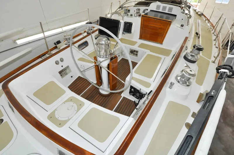 Slide: The Image of 1986 Hinckley Sou'wester 51 sailboat cockpit with wooden accents and steering wheel. - 23