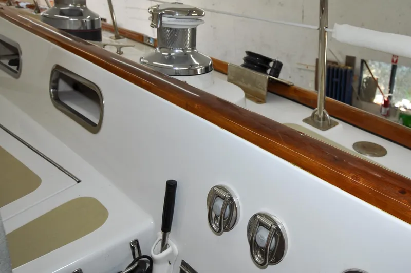 Slide: The Image of 1986 Hinckley Sou'wester 51 yacht deck with winches and polished wood trim. - 25
