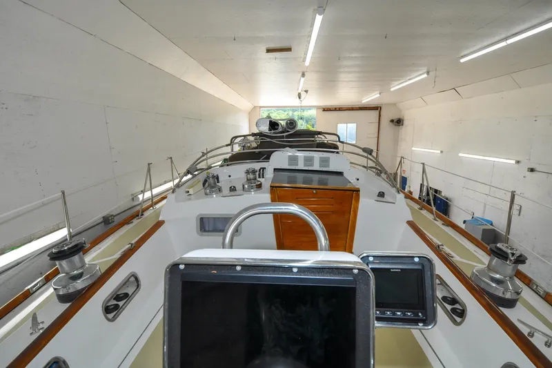 Slide: The Image of 1986 Hinckley Sou'wester 51 sailboat in a well-lit indoor storage facility. - 32