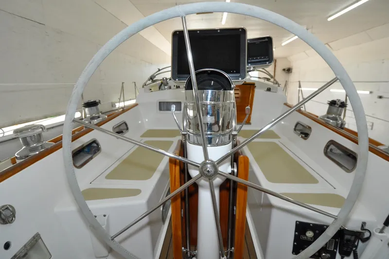 Slide: The Image of 1986 Hinckley Sou'wester 51 yacht cockpit with steering wheel and navigation equipment. - 33