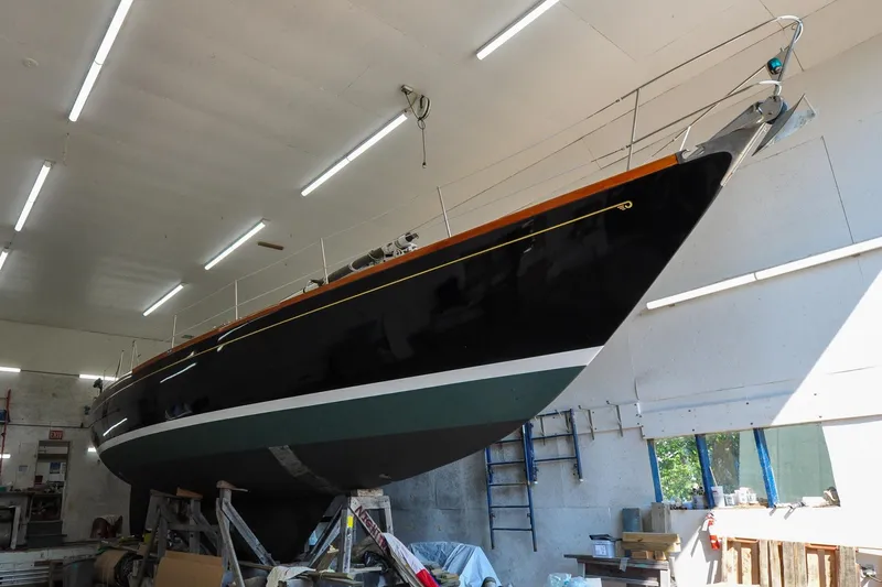 Slide: The Image of 1986 Hinckley Sou'wester 51 sailboat in a workshop, elevated for maintenance. - 4