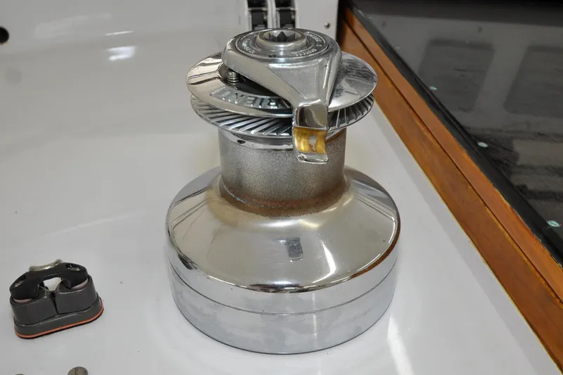 Slide: The Image of Chrome winch on 1986 Hinckley Sou'wester 51 sailboat deck, showcasing nautical equipment. - 45
