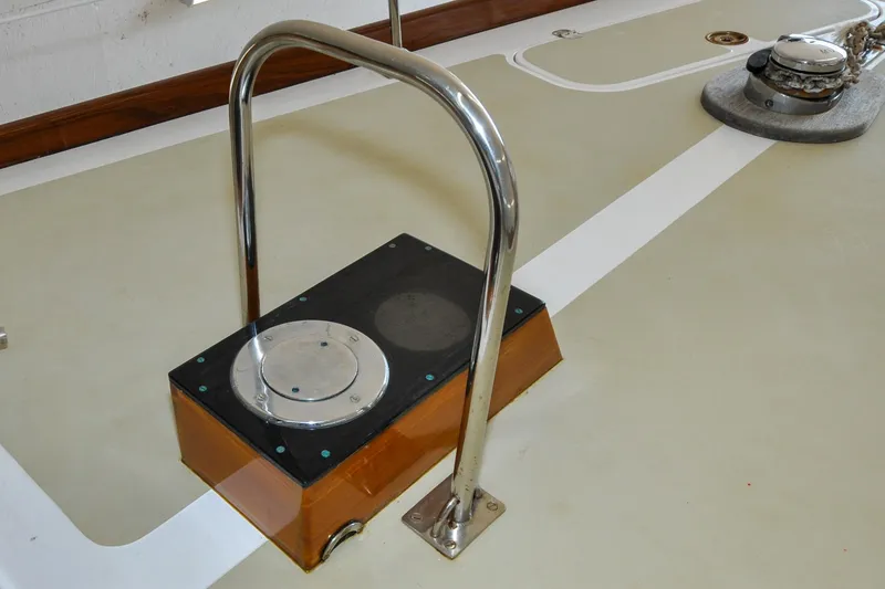 Slide: The Image of Deck detail of a 1986 Hinckley Sou'wester 51 sailboat, featuring a metal handrail. - 66