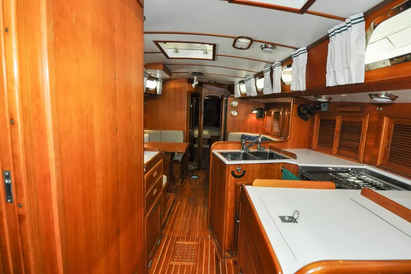 Slide: The Image of Interior of 1986 Hinckley Sou'wester 51 yacht with wooden cabinetry and modern amenities. - 73