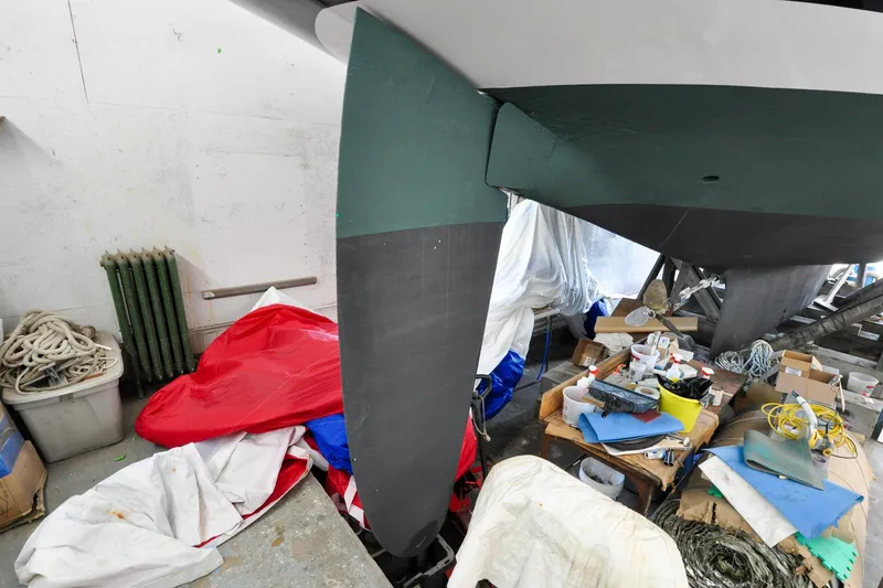 Slide: The Image of 1986 Hinckley Sou'wester 51 sailboat in workshop, surrounded by tools and materials. - 8